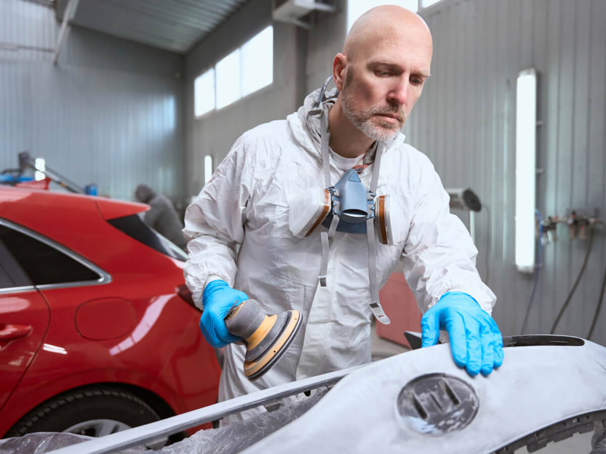 Technician repairing a vehicle at Al Serra Body Shop