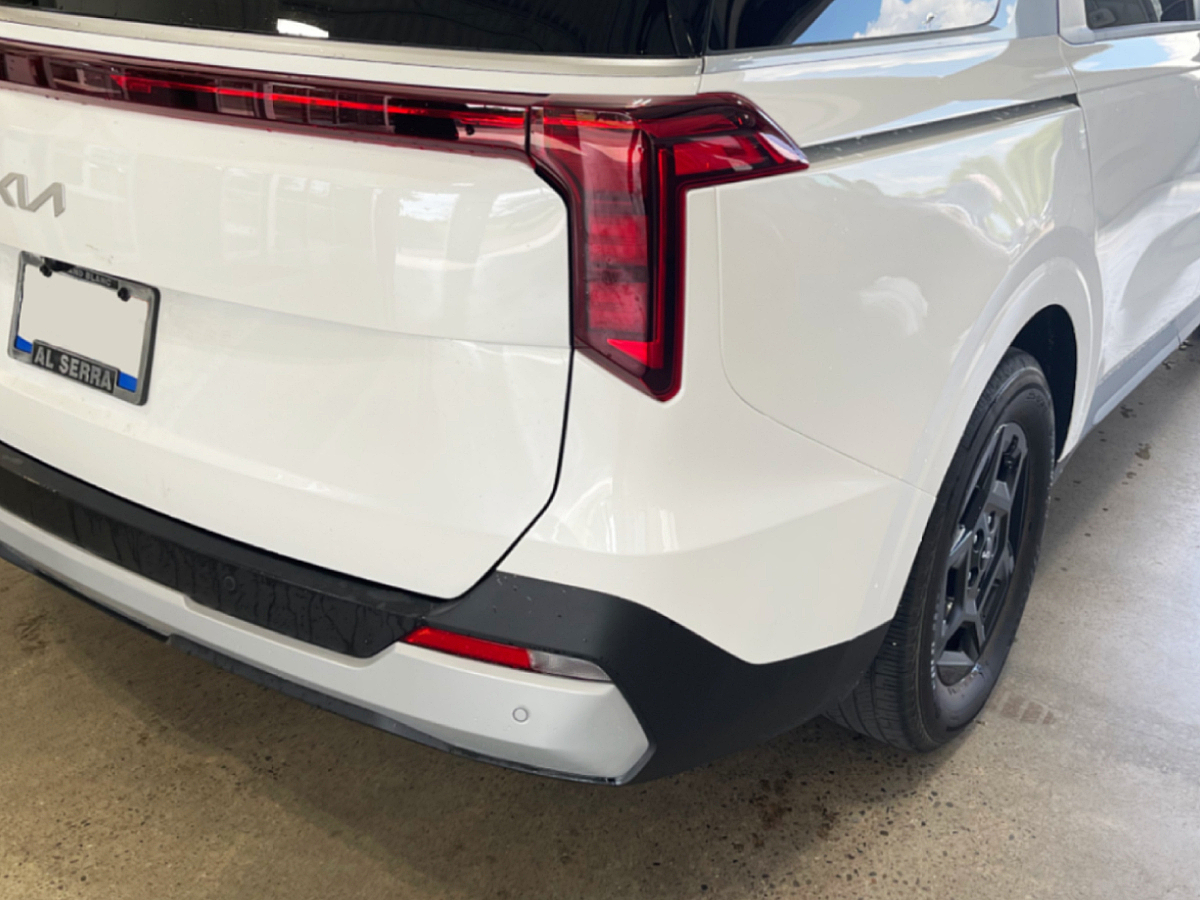 White Kia Carnival rear quarter panel and bumper restored to factory condition after collision repair at Al Serra Body Shop